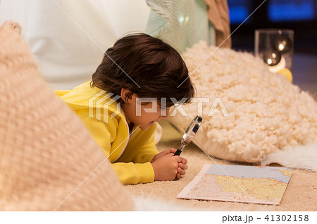 boy with magnifier and map in kids tent at home boy with magnifier and map in kids tent at home 41302158