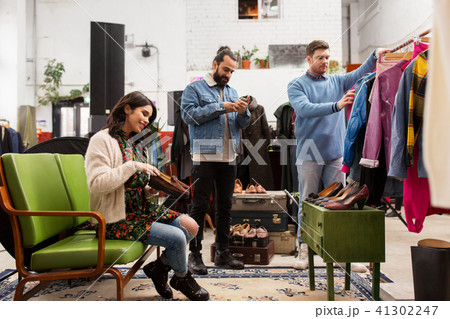 friends choosing clothes at vintage clothing store friends choosing clothes at vintage clothing store 41302247