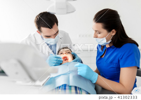 dentist checking for kid teeth at dental clinic 41302333