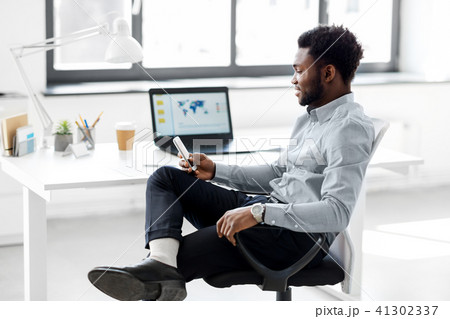 businessman with smartphone at office 41302337