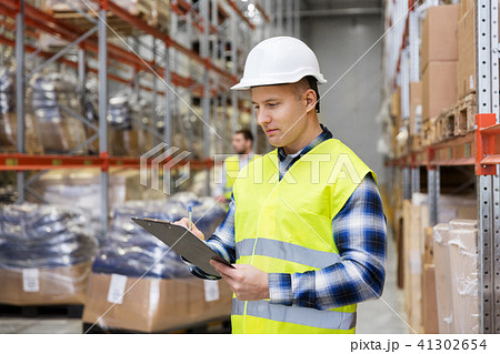 warehouse worker with clipboard in safety vest warehouse worker with clipboard in safety vest 41302654
