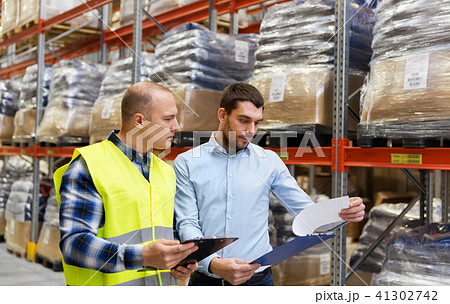 worker and businessman with clipboard at warehouse worker and businessman with clipboard at warehouse 41302742