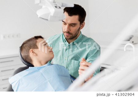 father supporting son at dental clinic father supporting son at dental clinic 41302904