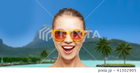 happy woman or teenage girl in sunglasses on beach 41302905