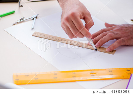 Architect working in his studio on new project Architect working in his studio on new project 41303098