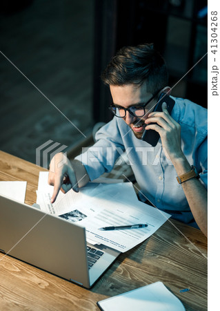 Working man with laptop having call Working man with laptop having call 41304268