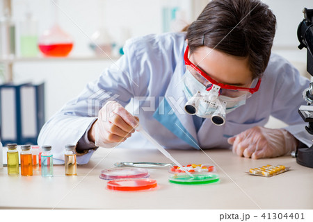Lab assistant in drug synthesis concept 41304401