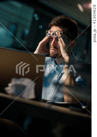 Sleepy worker using laptop Sleepy worker using laptop 41304628