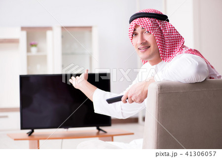 Arab man watching tv at home 41306057