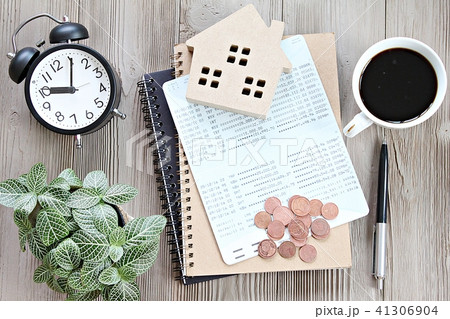 Wood house, savings book, coins on table Wood house, savings book, coins on table 41306904