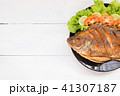 fried fish with vegetable on black dish. top view 41307187