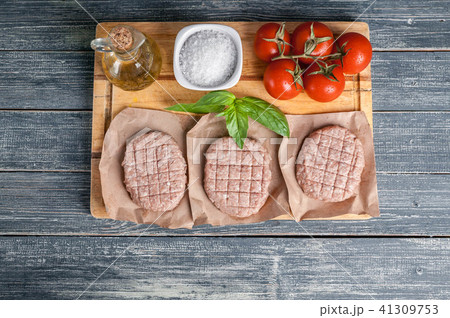 Chicken burgers cutlets on a wooden board Top view Chicken burgers cutlets on a wooden board Top view 41309753