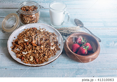 Granola with nuts, strawberries and glass of milk Granola with nuts, strawberries and glass of milk 41310063