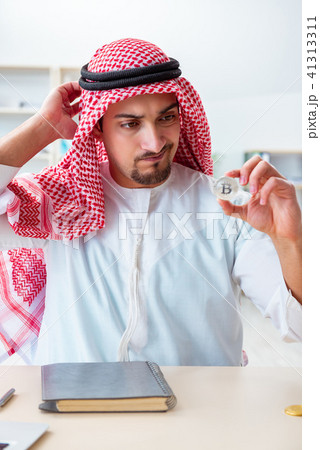 Arab man with bitcoin in cryptocurrency mining concept Arab man with bitcoin in cryptocurrency mining concept 41313311