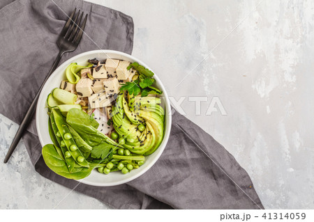Green buddha bowl with tofu, rice, avocado  41314059