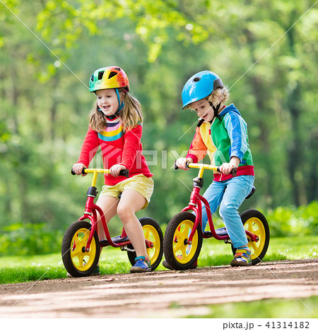 Kids ride balance bike in park 41314182 PIXTA