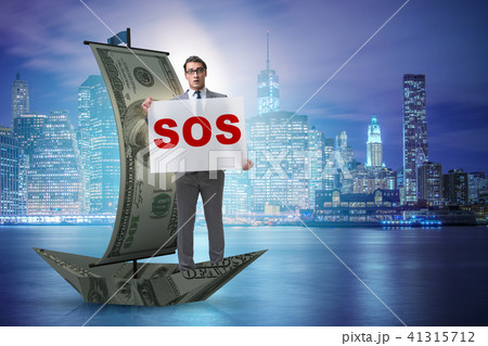 Businessman asking for help with SOS message on boat Businessman asking for help with SOS message on boat 41315712