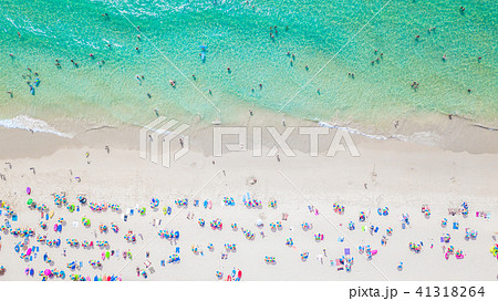 People bathing in the sun, swimming on the beach 41318264