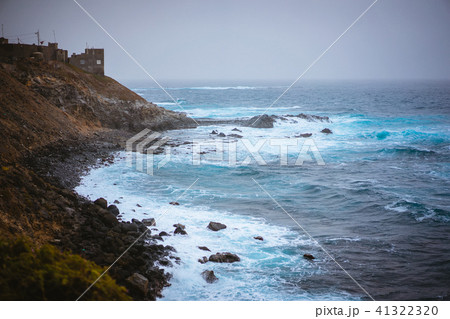 Bluff volcanic coastline in Sinagoga with stormy atlantic ocean. Trekking trail from Ponta do Sol to 41322320