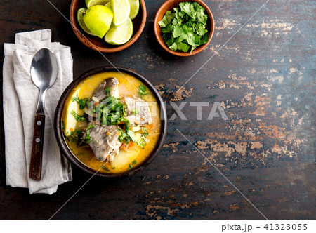 CHILEAN FOOD. Fish soup CALDILLO DE CONGRIO served in clay bowl, top view. copy space 41323055