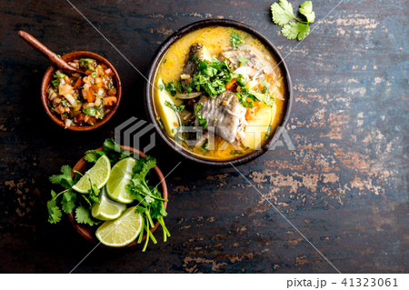 CHILEAN FOOD. Fish soup CALDILLO DE CONGRIO served in clay bowl, top view. copy space 41323061