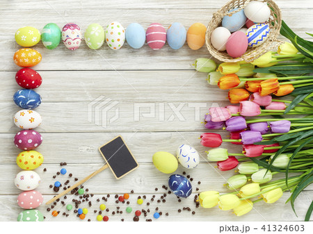 Colorful Easter eggs and tulips on wood Colorful Easter eggs and tulips on wood 41324603
