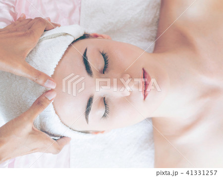 Woman gets facial and head massage in luxury spa. 41331257