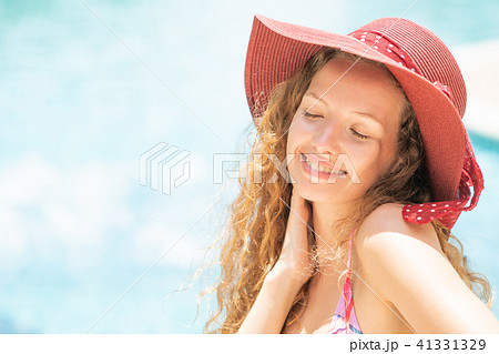 Happy young woman in swimsuit at swimming pool. Happy young woman in swimsuit at swimming pool. 41331329