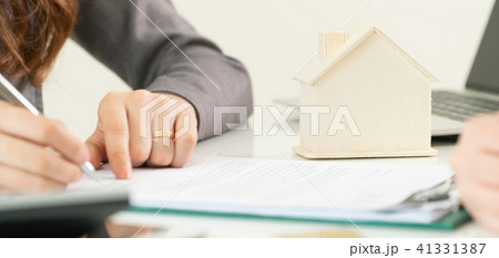 Client Signs Document to Buy House and Real Estate 41331387