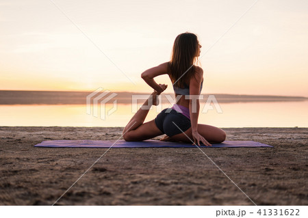 yoga woman on the beach at sunset. yoga woman on the beach at sunset. 41331622
