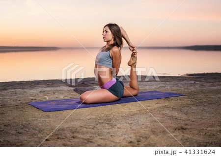 yoga woman on the beach at sunset. yoga woman on the beach at sunset. 41331624