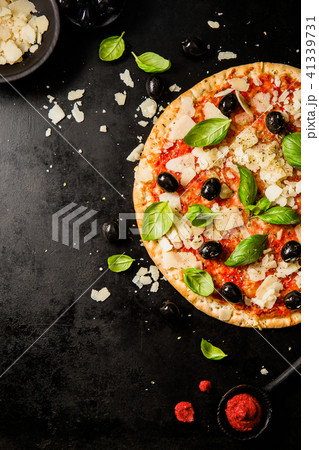 Traditional italian pizza on dark table Traditional italian pizza on dark table 41339731