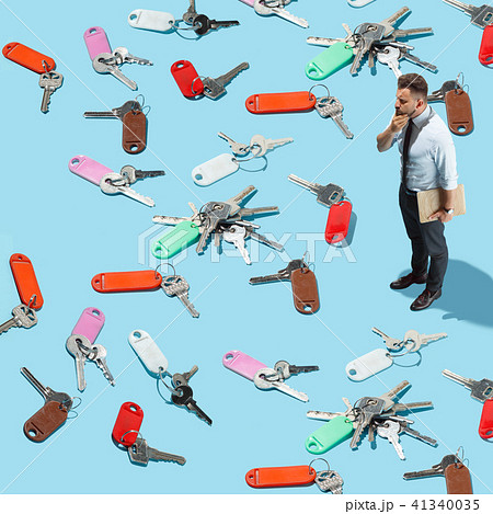 Businessman try to find the key from many keys 41340035