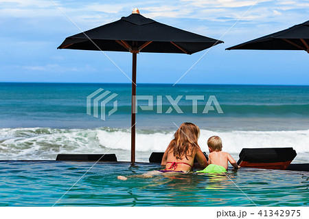 Mother with son chilling in beach swimming pool Mother with son chilling in beach swimming pool 41342975