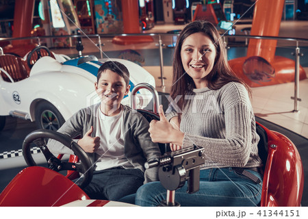 Happy smiling mother and son in toy car Happy smiling mother and son in toy car 41344151