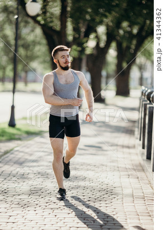 Morning jogging, man running in the city park 41344362