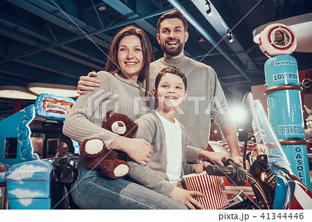 Happy family sitting on toy motorbike 41344446