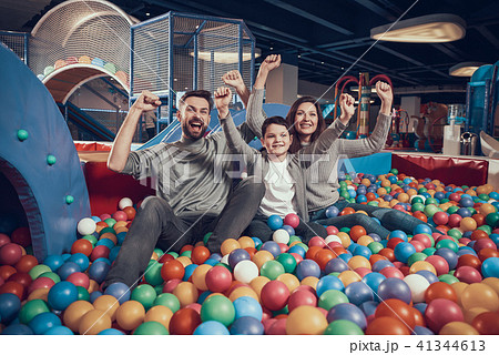 Glad family sitting in pool with balls Glad family sitting in pool with balls 41344613