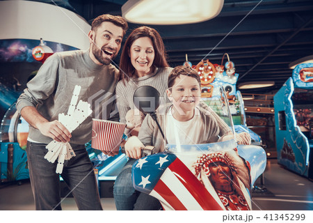 Happy family sitting on toy motorbike 41345299
