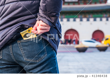 Man pulls the korean money from his jeans pocket Man pulls the korean money from his jeans pocket 41346438