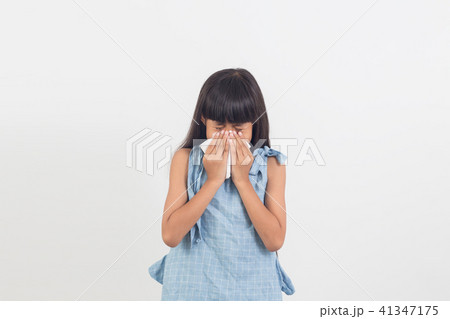 sick little girl blowing her nose isolated on whit sick little girl blowing her nose isolated on whit 41347175