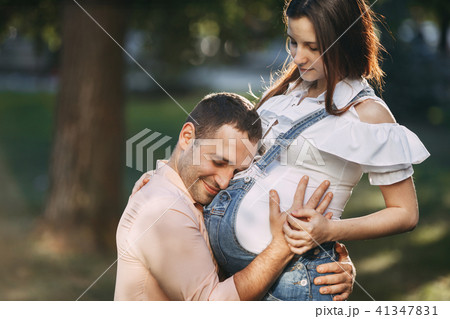 Father expecting for baby hugging his wife belly 41347831