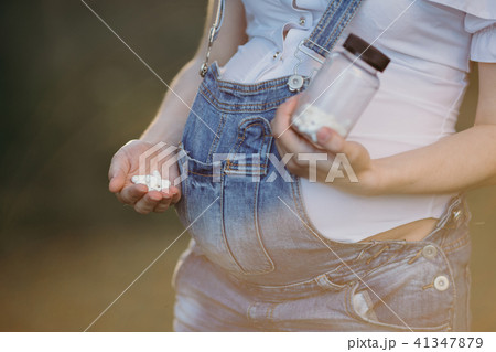 Pregnant woman taking pills 41347879