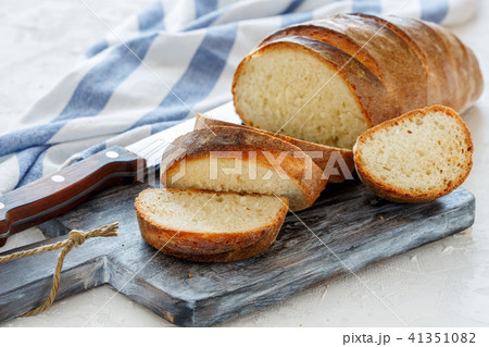 Freshly baked loaf cut into slices. Freshly baked loaf cut into slices. 41351082