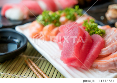 Mixed sliced fish sashimi in white plate.  41352781