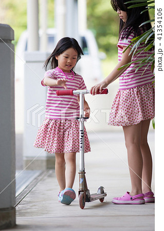 スクーターを遊んでいる子供姉妹 41354106
