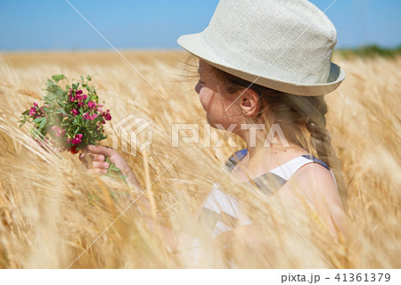 child girl walking in the yellow wheat field 41361379