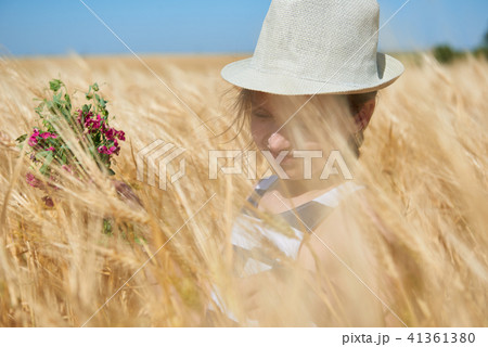 child girl walking in the yellow wheat field 41361380