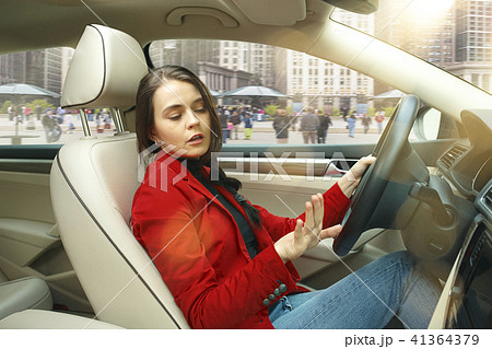 Driving around city. Young attractive woman driving a car 41364379