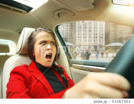 Driving around city. Young attractive woman driving a car 41367301